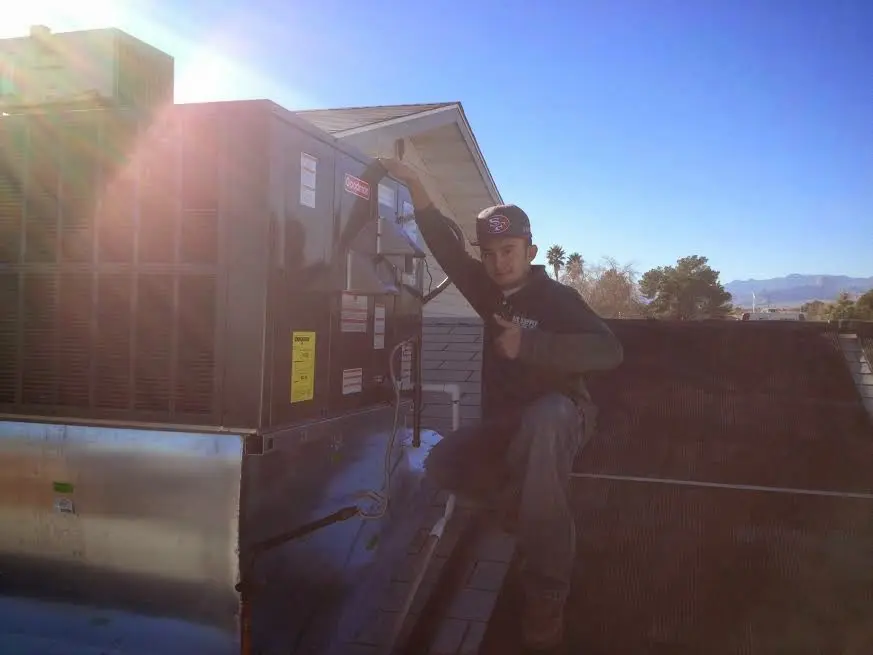 HVAC technician performing HVAC Inspection on a rooftop unit in River Vale